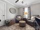 Cozy sitting area with comfortable armchairs, plush ottoman, and textured area rug at 3020 Salmon River Dr, Monroe, NC 28110