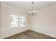 Bright dining room features decorative molding, hardwood floors, and a modern chandelier at 326 Nantucket Way, Rock Hill, SC 29732