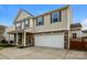 Charming two-story home with stone accents, a well-manicured lawn, and a two-car garage at 326 Nantucket Way, Rock Hill, SC 29732
