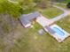 Overhead shot of the home, surrounded by a well-kept yard, long driveway, and enticing swimming pool at 3452 Flat Creek Rd, Lancaster, SC 29720