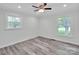 Bright bedroom with two windows, neutral tones, wood floors and ceiling fan at 3452 Flat Creek Rd, Lancaster, SC 29720