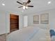 Neutral-toned bedroom featuring a wood-lined closet, light wood floors, and bright natural light at 3452 Flat Creek Rd, Lancaster, SC 29720