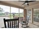Serene screened patio with brick flooring, rocking chairs, and views of the backyard at 3452 Flat Creek Rd, Lancaster, SC 29720