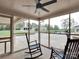 Relaxing screened patio featuring rocking chairs and a fan, perfect for enjoying the outdoor scenery at 3452 Flat Creek Rd, Lancaster, SC 29720