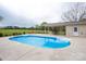 Backyard pool with patio, lounge chairs, and a covered outdoor dining area surrounded by green landscaping at 3452 Flat Creek Rd, Lancaster, SC 29720