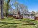 Exterior image showcasing the home's well-maintained lawn and deck at 3489 Lake Shore S Rd, Denver, NC 28037