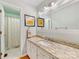 Bright bathroom featuring a granite countertop, framed mirror, and a shower and tub combination at 3489 Lake Shore S Rd, Denver, NC 28037