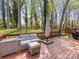 Outdoor deck with modern furniture and shade umbrella overlooking a lawn at 3489 Lake Shore S Rd, Denver, NC 28037