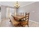 Inviting dining room featuring a wooden table, chairs and bench, plus elegant chandelier at 3489 Lake Shore S Rd, Denver, NC 28037