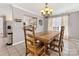 Cozy dining room with rustic wood table, chandelier, and lots of natural light at 3489 Lake Shore S Rd, Denver, NC 28037