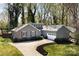 Charming gray home with a long driveway and manicured lawn in a wooded setting at 3489 Lake Shore S Rd, Denver, NC 28037