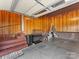 Spacious garage with stairs, brick accent wall, and side entry door at 3489 Lake Shore S Rd, Denver, NC 28037