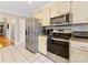 Traditional kitchen with stainless steel appliances, neutral cabinets, and tile flooring at 3489 Lake Shore S Rd, Denver, NC 28037