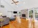 Bright living room with stone fireplace, hardwood floors, and access to the deck at 3489 Lake Shore S Rd, Denver, NC 28037