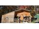 Rustic barn with wooden siding, including outbuildings and decorative farm accents in a wooded setting at 368 Northwood Dr, Troy, NC 27371