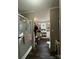 Bright bathroom area includes a shower, and leads to a storage area with a counter and dark flooring at 368 Northwood Dr, Troy, NC 27371