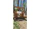 Rustic chicken coop with wooden panels and decorative signage surrounded by natural scenery at 368 Northwood Dr, Troy, NC 27371