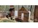 Rustic farm scene featuring a wooden playhouse, hay bales, and a quaint country setting at 368 Northwood Dr, Troy, NC 27371