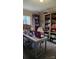 Office area with an antique desk, bookshelves, and natural light at 368 Northwood Dr, Troy, NC 27371
