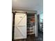 Charming pantry with sliding barn door and ample storage space on shelves and in hanging baskets at 368 Northwood Dr, Troy, NC 27371