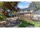 Scenic backyard featuring a unique gazebo, lush landscaping, and serene pond feature at 3916 Riverbend Rd, Charlotte, NC 28210
