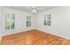 Bedroom with hardwood floors, three shuttered windows, white walls, and a classic trim at 3916 Riverbend Rd, Charlotte, NC 28210