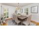 Dining room features stylish chandelier, shuttered windows, and a dark wood table with seating for six at 3916 Riverbend Rd, Charlotte, NC 28210