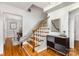 Elegant foyer showcasing hardwood floors, decorative stairway, and stylish console table with mirror at 3916 Riverbend Rd, Charlotte, NC 28210