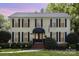 Charming yellow two-story house with black shutters and a well-manicured front yard at 3916 Riverbend Rd, Charlotte, NC 28210