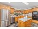 Traditional kitchen with stainless steel appliances, light wood cabinetry, and unique slate flooring at 3916 Riverbend Rd, Charlotte, NC 28210