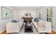 Bright living room featuring neutral sofas, stylish decor, and ample natural light from shuttered windows at 3916 Riverbend Rd, Charlotte, NC 28210