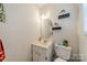 Cozy bathroom featuring a single sink vanity with decorative mirror and plants at 417 Donna Ave, Gastonia, NC 28052