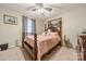 Comfortable bedroom with a four-poster bed, soft carpet, and a decorative painting at 417 Donna Ave, Gastonia, NC 28052