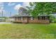 Charming single-story brick home featuring shuttered windows and a well-maintained lawn at 417 Donna Ave, Gastonia, NC 28052