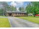 Charming brick home with a covered carport, long driveway, shutters, and manicured lawn at 417 Donna Ave, Gastonia, NC 28052