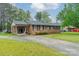Charming brick home with a covered carport, long driveway, shutters, and manicured lawn at 417 Donna Ave, Gastonia, NC 28052