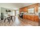 Functional kitchen featuring wood cabinets, a dining area, and a sliding glass door to the backyard at 417 Donna Ave, Gastonia, NC 28052