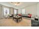Inviting living room with neutral colors, a ceiling fan, and large windows providing natural light at 417 Donna Ave, Gastonia, NC 28052