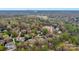 Aerial view of sprawling suburban homes nestled within a mature forest landscape at 4300 Old Course Dr, Charlotte, NC 28277