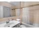 Bright bathroom features tiled walls, white vanity, and a shower with curtain at 4300 Old Course Dr, Charlotte, NC 28277