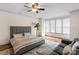 Bedroom with hardwood floors, ceiling fan, and large windows offering great light at 4300 Old Course Dr, Charlotte, NC 28277
