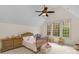 Cozy bedroom with a wood crib, ample natural light, and a ceiling fan at 4300 Old Course Dr, Charlotte, NC 28277