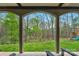 Arched covered patio looking out onto a lush lawn and wooded area at 4300 Old Course Dr, Charlotte, NC 28277