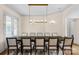 Formal dining room with a long wooden table, seating for ten, and elegant lighting fixtures at 4300 Old Course Dr, Charlotte, NC 28277