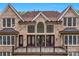 Rear exterior of a brick home with a balcony, large windows and a landscaped yard at 4300 Old Course Dr, Charlotte, NC 28277