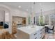 Open-concept kitchen featuring an island, stone countertops, modern appliances and fixtures at 4300 Old Course Dr, Charlotte, NC 28277