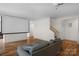 Spacious living room with projector and screen, hardwood floors, and ample natural light at 4300 Old Course Dr, Charlotte, NC 28277