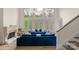 Bright living room with a fireplace, large windows, plush blue sofas, and hardwood flooring at 4300 Old Course Dr, Charlotte, NC 28277