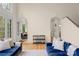 Cozy living area with blue sofas, hardwood floors, and a view into a dining room and hallway at 4300 Old Course Dr, Charlotte, NC 28277