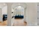 Elegant living room with hardwood floors, large windows, and a view of the lush outdoors at 4300 Old Course Dr, Charlotte, NC 28277